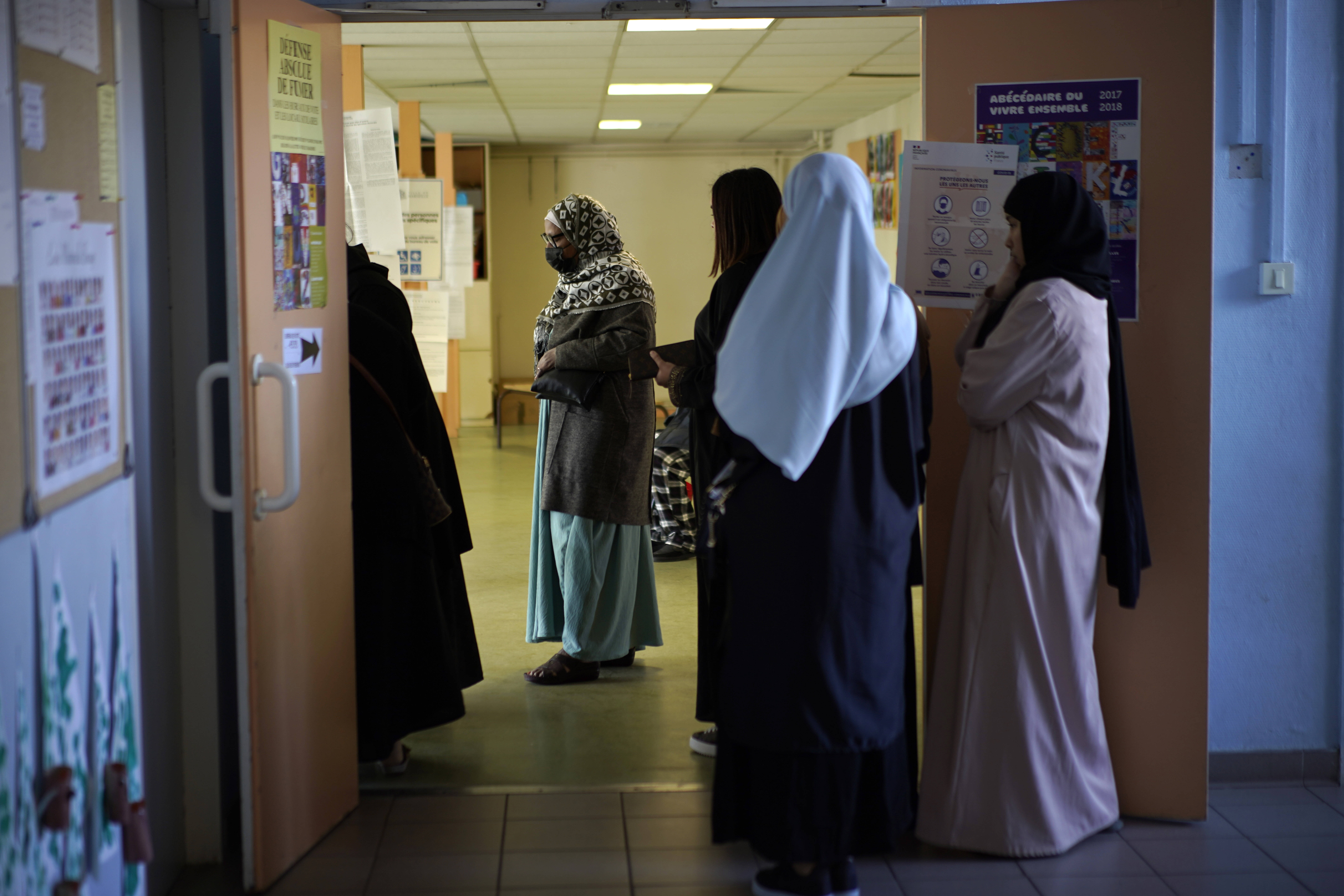 France's education minister announced that long robes in classrooms would be banned starting with the new school year, saying that secularism in the nation's schools is being "tested" via the garments, worn mainly by Muslims. (Daniel Cole/AP)