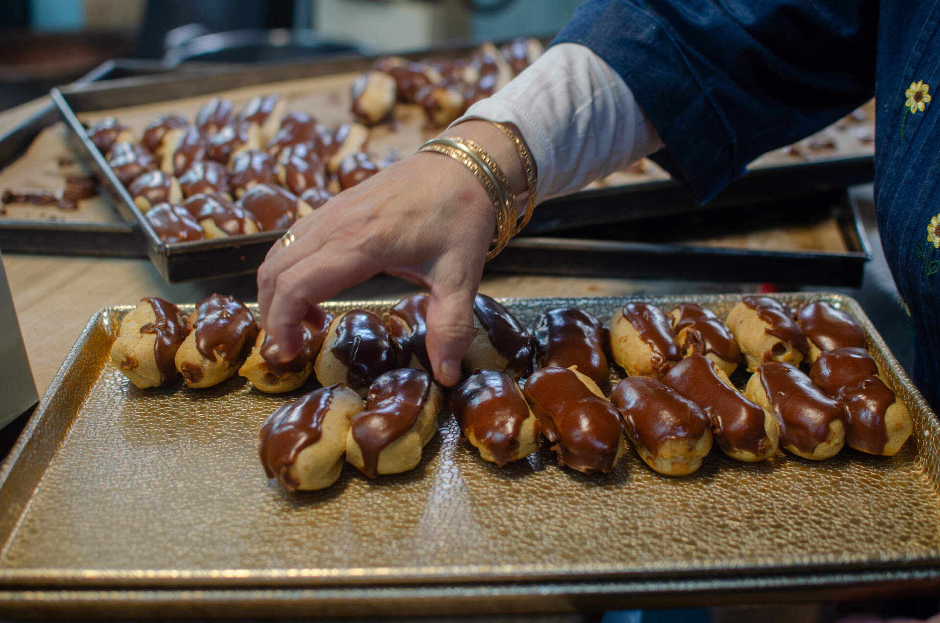 Kappas in the kitchen of New Paris Bakery, preparing eclairs. (Sharon Brody/WBUR)
