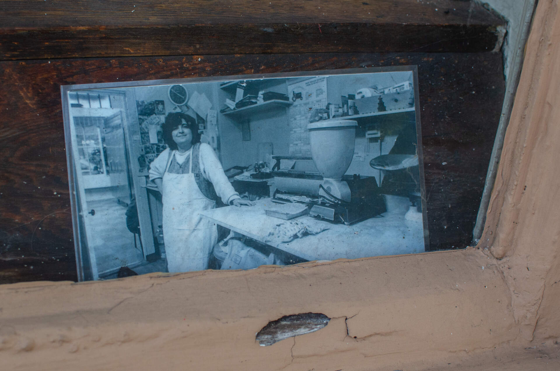 A photo in the shop window shows Roula Kappas in the New Paris Bakery decades ago. (Sharon Brody/WBUR)