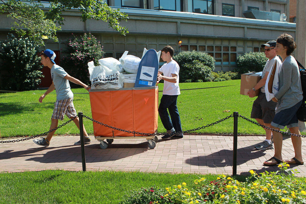 Matt Hacker Teper, left, helps his brother Sean Hacker Teper move in to his West Campus dorm at Boston University on September 2, 2023. (David L Ryan/The Boston Globe via Getty Images)