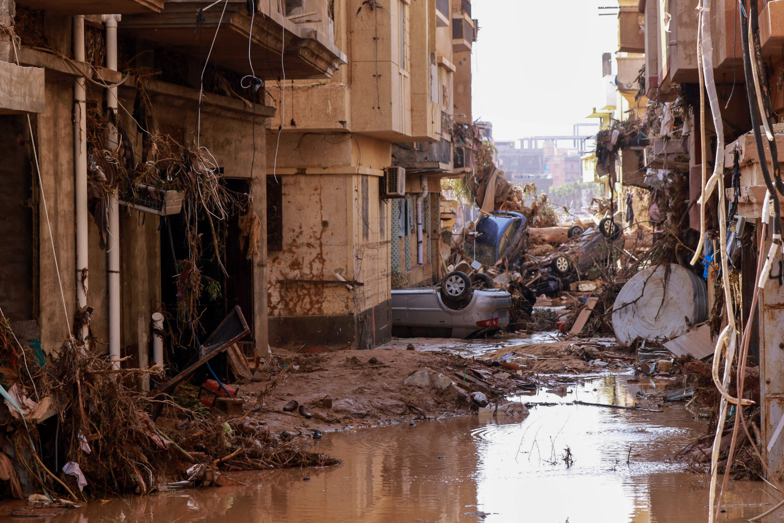 Overturned cars lay among other debris caused by flash floods in Derna, eastern Libya, on Sept. 11, 2023. (AFP via Getty Images)