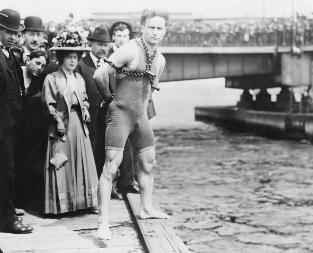 Magician Harry Houdini prepares to jump into the Charles River, with his hands chained behind his back, on April 30, 1908. (Photo courtesy Library of Congress/Getty Images)