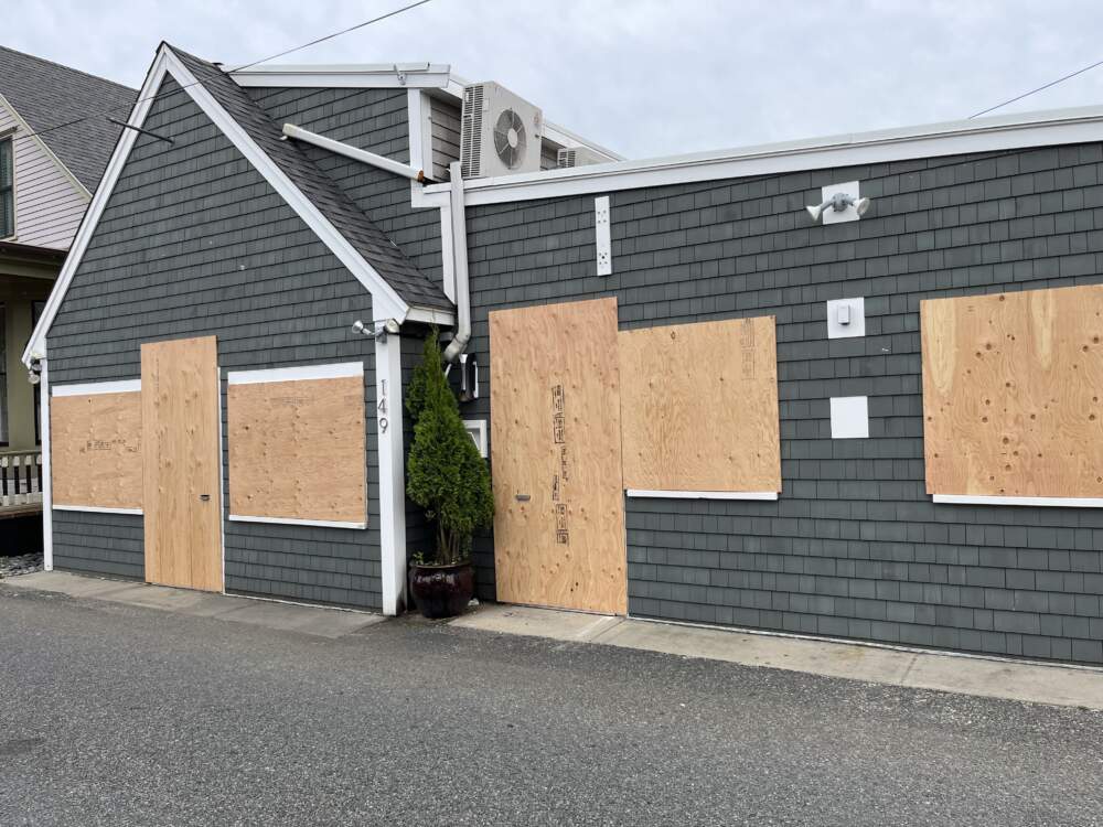 The Monkey Bar in Provincetown was boarded up ahead of Hurricane Lee's arrival off the coast of Cape Cod. (Beth Healey/WBUR)