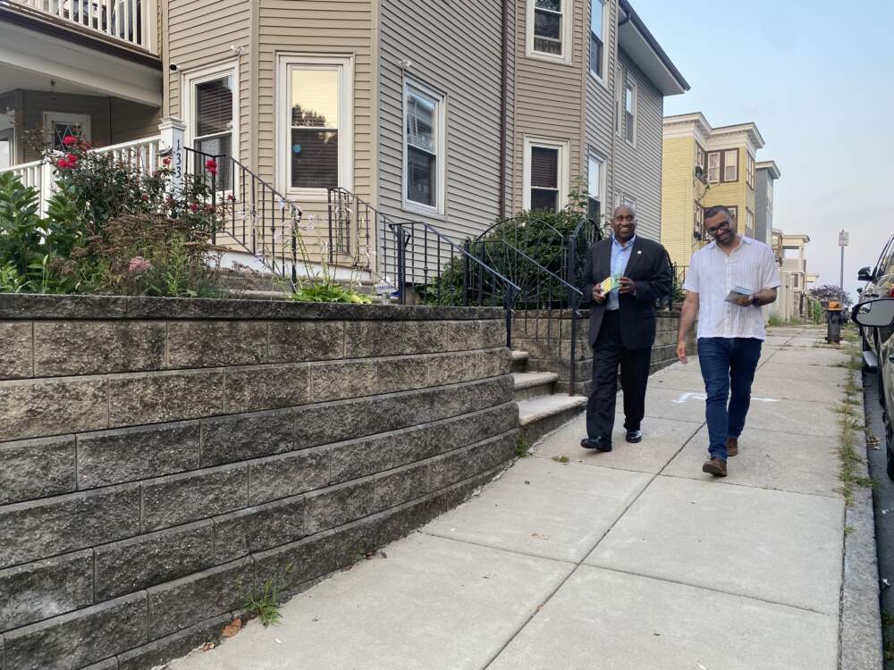 State Rep. Russell Holmes and Boston City Councilor Ricardo Arroyo knock doors in Mattapan. (Walter Wuthmann/WBUR).