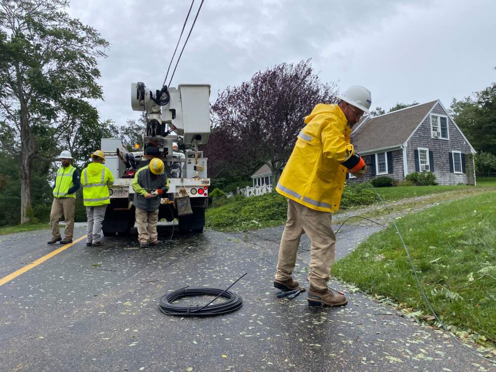 Contractors for Eversource repair a power line that was taken out by a fallen tree in Brewster (Miriam Wasser/WBUR)