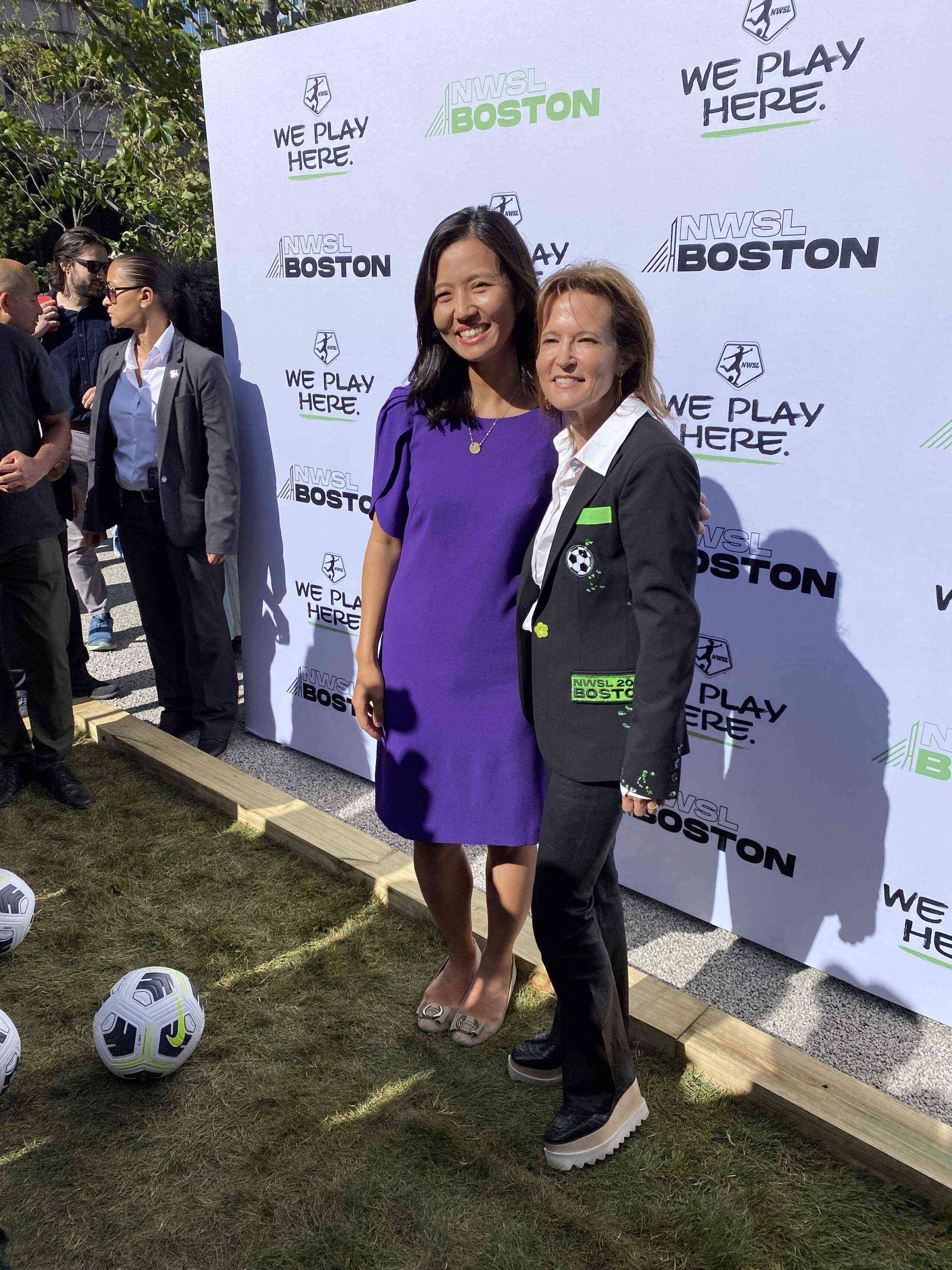 Boston Mayor Michelle Wu and Boston Unity Soccer Partners principal Jennifer Epstein celebrate the city's successful bid for a new professional women's soccer team (Walter Wuthmann/WBUR).