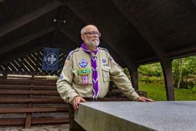 Tom Andrew stands at the altar of the outdoor chapel at Griswold Scout Reservation near Gilmanton, New Hampshire. (Jesse Costa/WBUR)