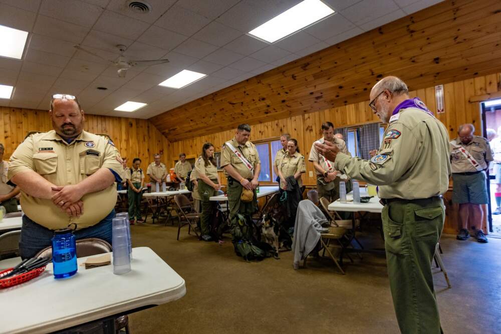 Tom Andrew offers grace at the weekly scoutmasters' dinner. (Jesse Costa/WBUR)