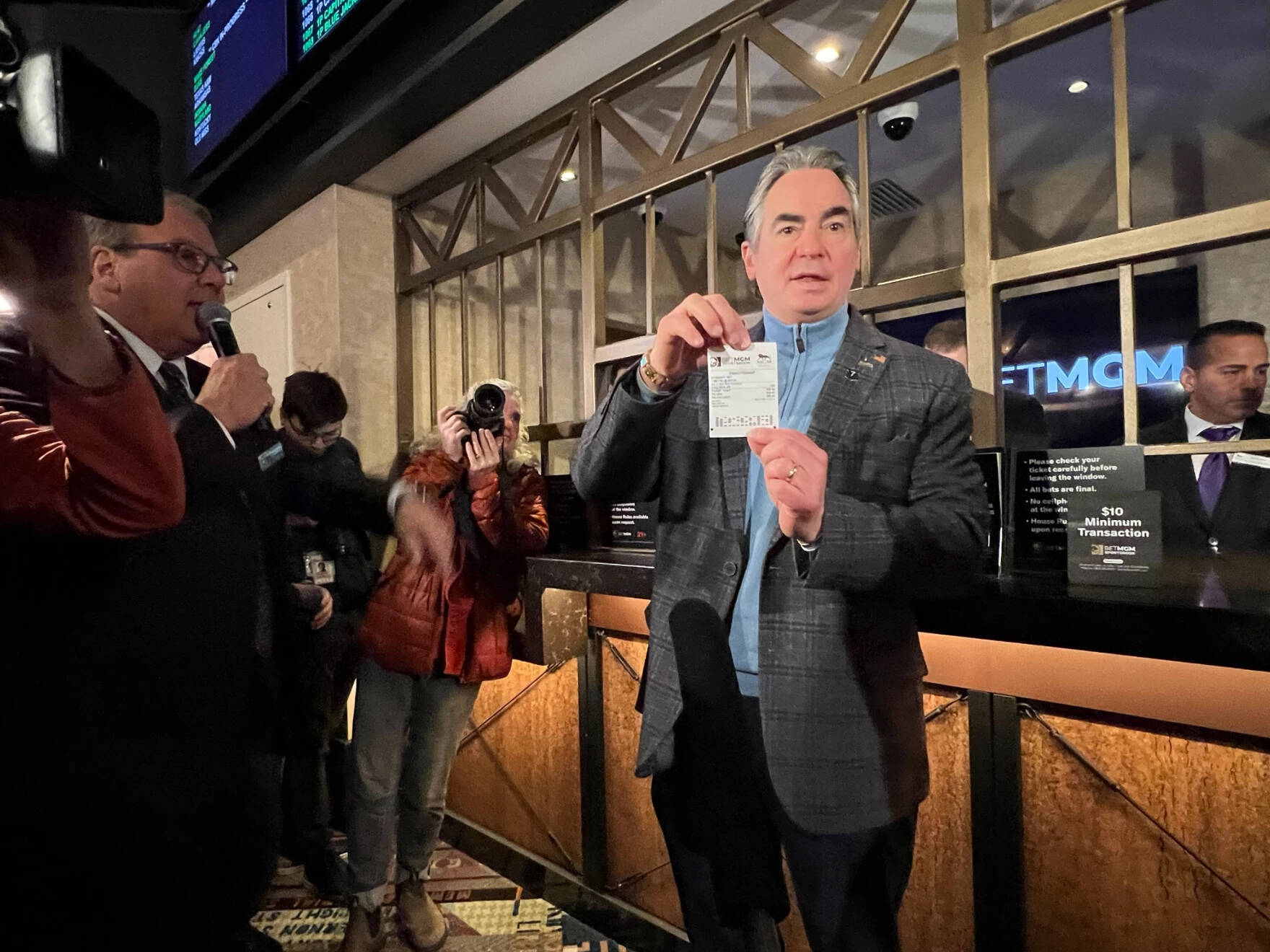 Springfield Mayor Domenic Sarno purchases the first sports betting ticket at MGM Springfield on Tuesday, Jan. 31, 2023. (Adam Frenier/NEPM)