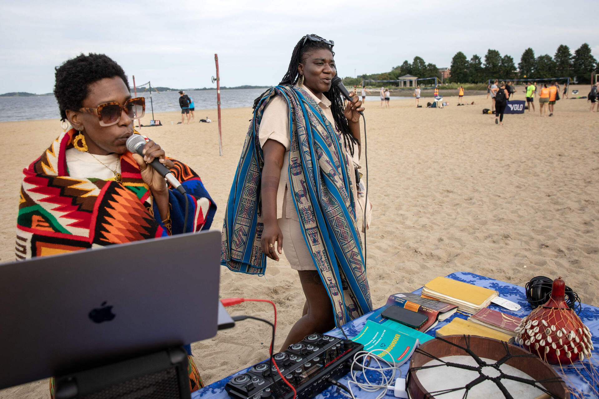 Vocalist Thamanai and performance artist Dzidzor sing together at a rest activation at Carson Beach in Boston. (Robin Lubbock/WBUR)