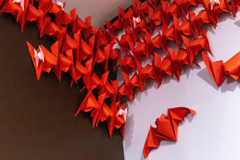 Hundreds of red origami bats created by artists Michael LaFosse and Richard Alexander roost in the back corner of the “Bats!” exhibition at the Peabody Essex Museum. (Jesse Costa/WBUR)