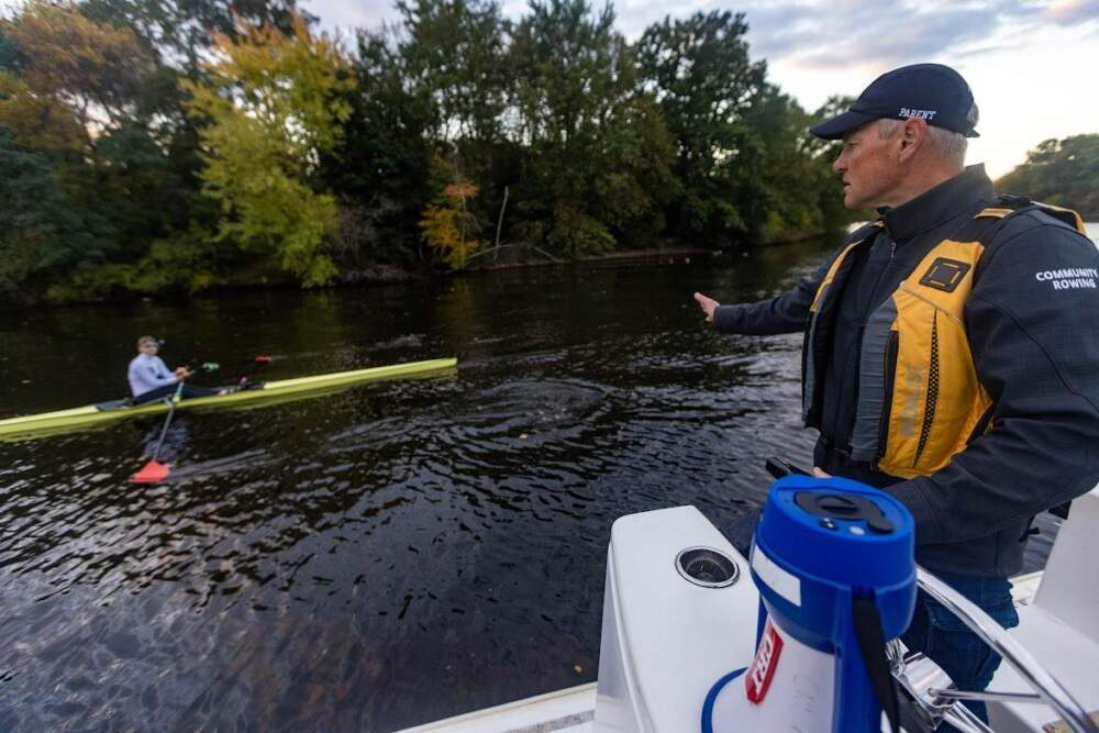 Coach Anton Prodan gives his daughter Maria some guidance during her practice run along the Charles River. (Jesse Costa/WBUR)