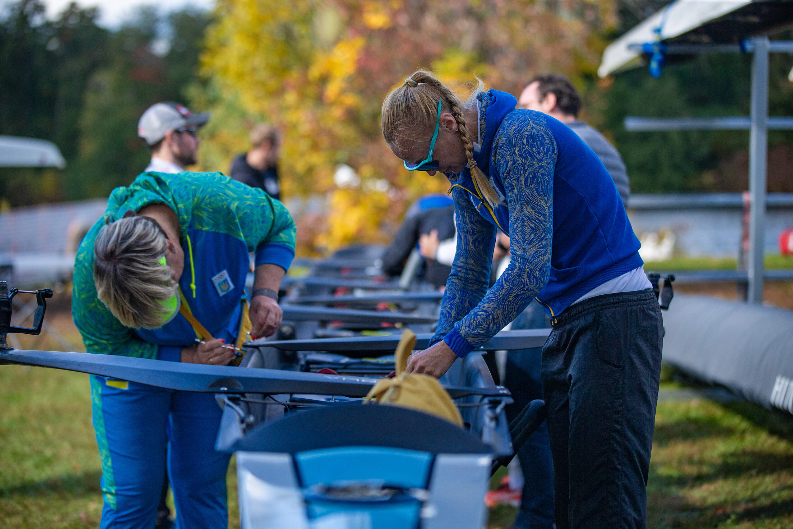 The Ukrainian national rowing team outfits a shell with rigging. (Jesse Costa/WBUR)