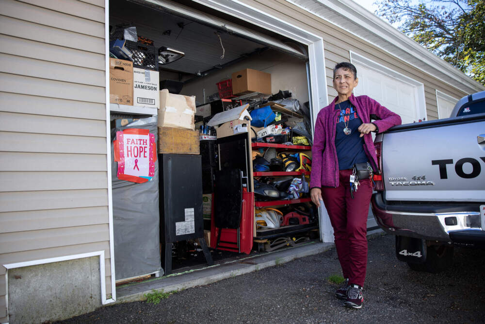 Angie Vargas stands outside her storage unit in New Bedford, next to the pickup truck she's lived out of since July. (Robin Lubbock/WBUR)