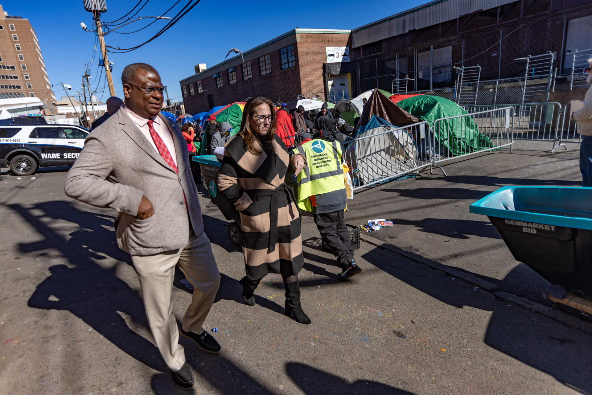 Boston Police Superintendent Michael Cox and Chief of Staff Nicole Taub survey ongoing work by the city on Tuesday ahead of Wednesday's tent removals. (Jesse Costa/WBUR)