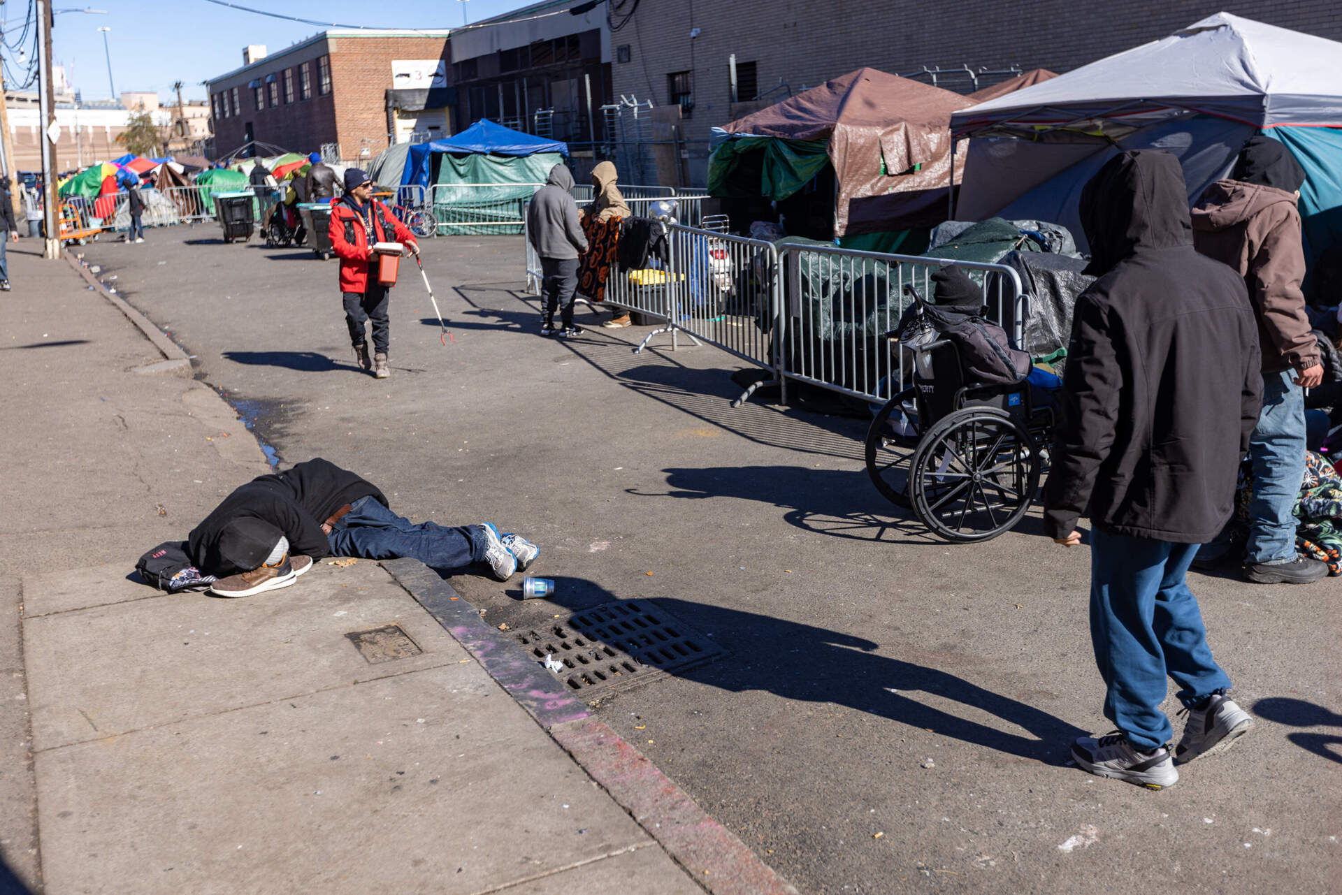 The scene on Atkinson Street Tuesday as city workers look to relocate people living in the encampment ahead of Wednesday's removal of the tents by police. (Jesse Costa/WBUR)