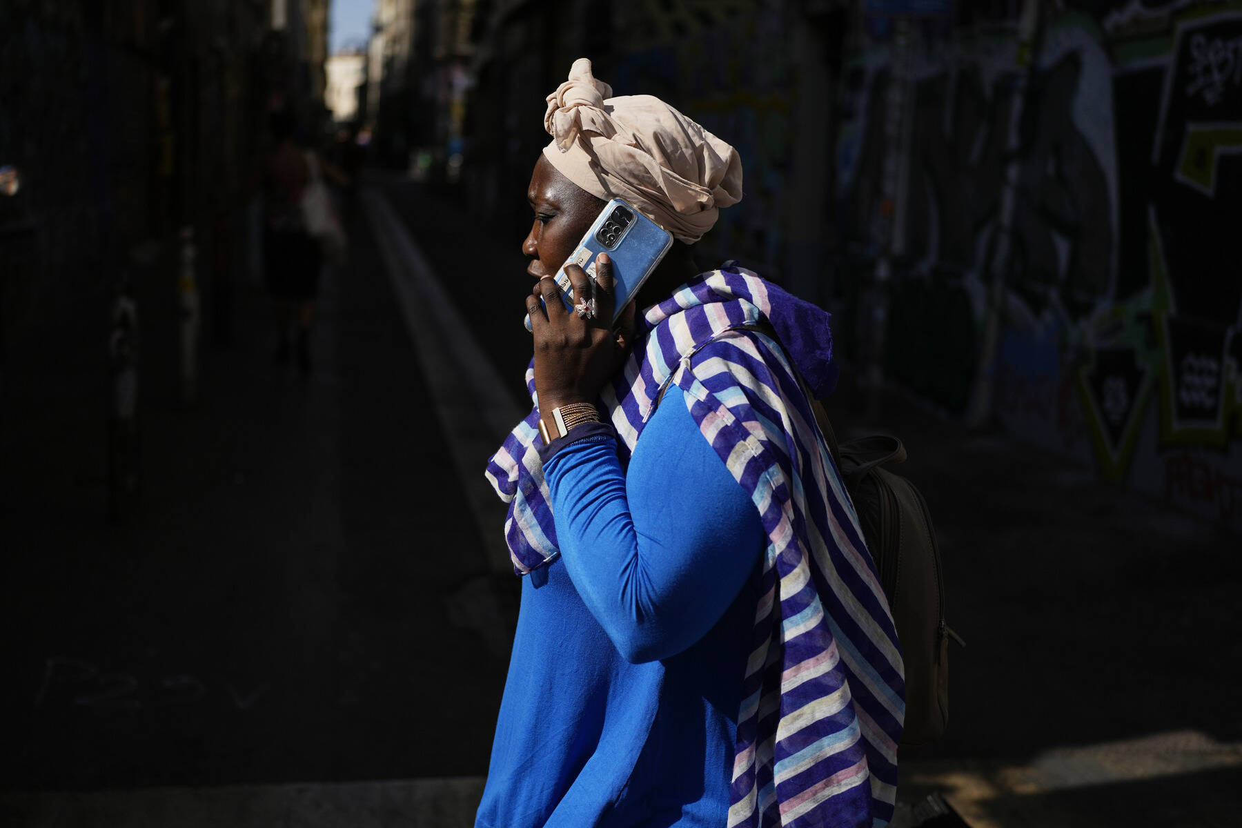 A woman talks on a cell phone. (Pavel Golovkin/AP)