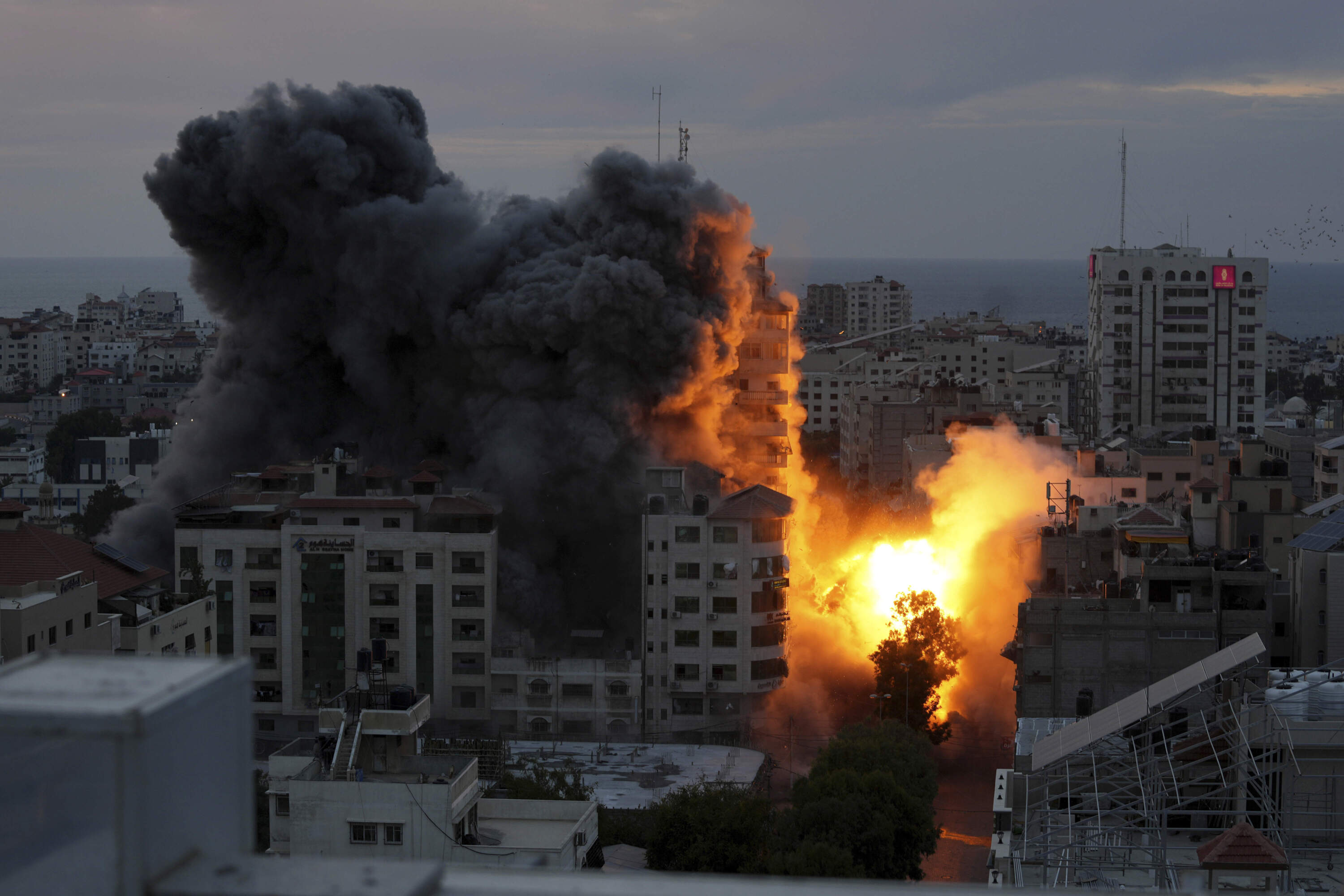 A ball of fire and smoke rise from an explosion on a Palestinian apartment tower following an Israeli air strike in Gaza City, Saturday, Oct. 7, 2023. The militant Hamas rulers of the Gaza Strip carried out an unprecedented, multi-front attack on Israel at daybreak Saturday. (Adel Hana/AP)
