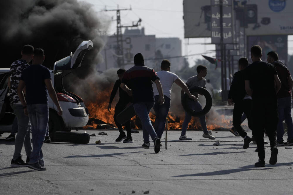 Palestinian demonstrators clash with Israeli forces following a demonstration in support of the Gaza Strip, in the West Bank city of Nablus, Friday, Oct. 13, 2023. (Majdi Mohammed/AP)
