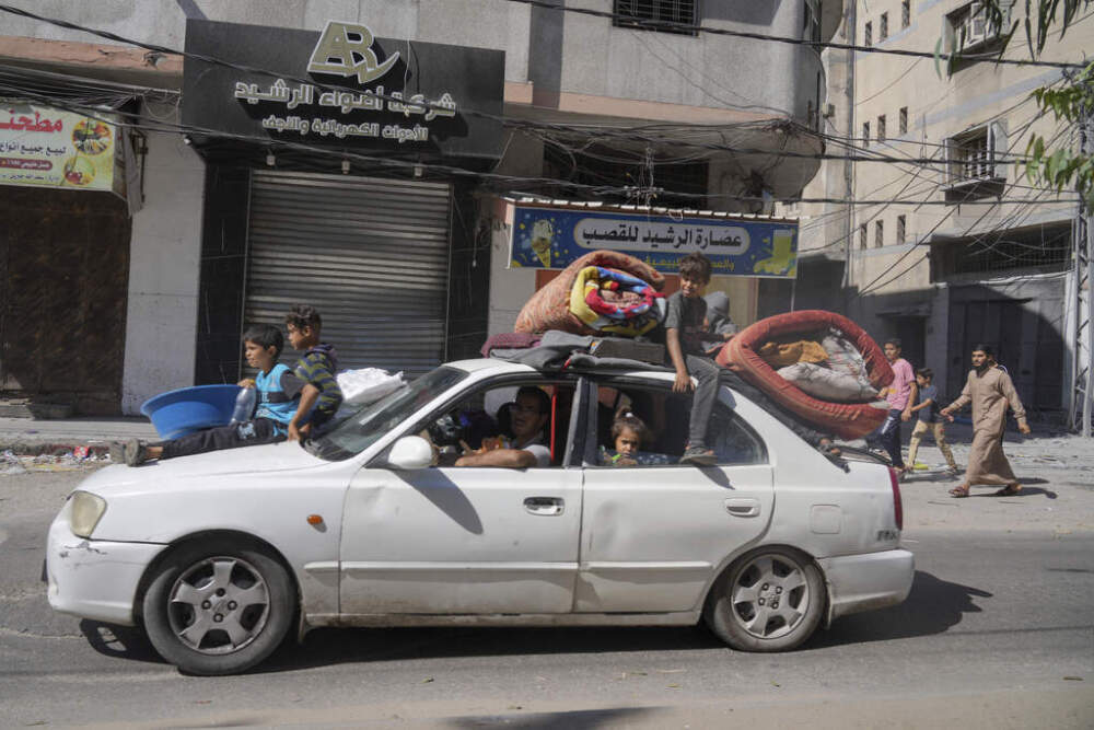 Palestinians fleeing from northern Gaza to the south with their belongings stacked on their cars after the Israeli army issued an unprecedented evacuation warning to a population of over 1 million people in northern Gaza and Gaza City to seek refuge in the south ahead of a possible Israeli ground invasion, Friday, Oct. 13, 2023. (Hatem Moussa/AP)