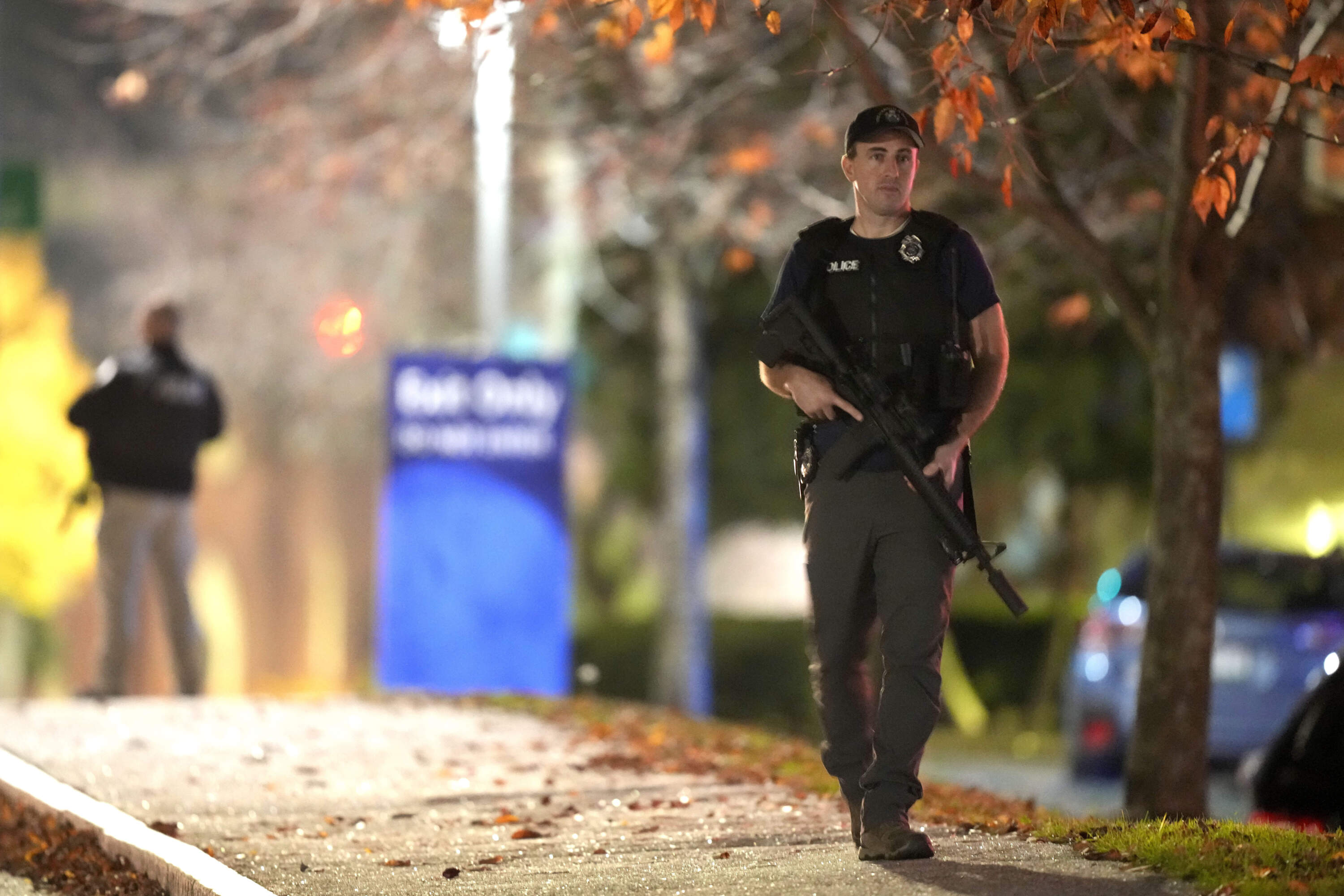 Law enforcement officers carry rifles outside Central Maine Medical Center during an active shooter situation, in Lewiston, Maine, Wednesday, Oct. 25. (Steven Senne/AP)