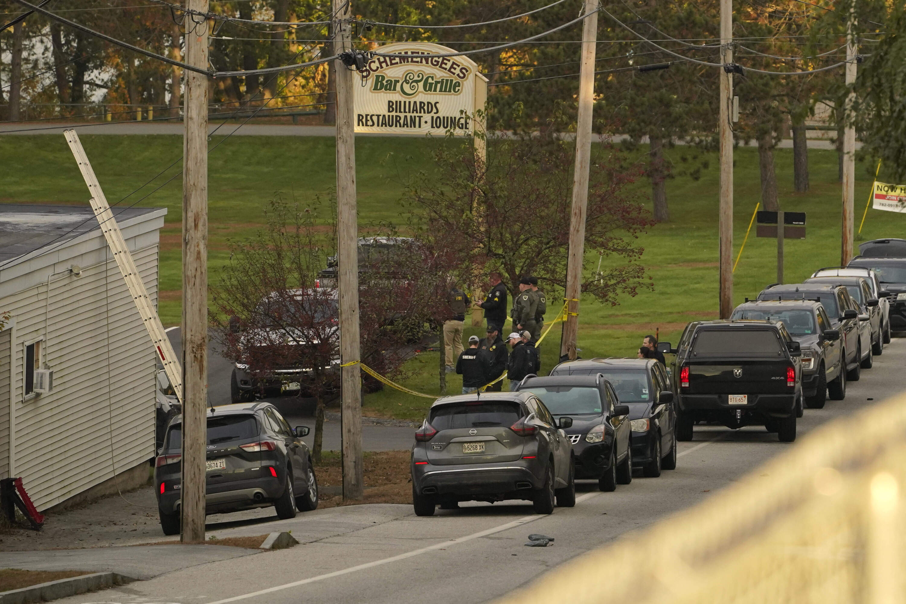 Law enforcement gather Thursday morning outside Schemengee's Bar and Grille in Lewiston, Maine. (Robert F. Bukaty/AP)