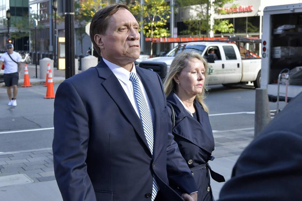 John Wilson, left, and his wife leave federal court in Boston, Oct. 8, 2021. (Josh Reynolds/AP)