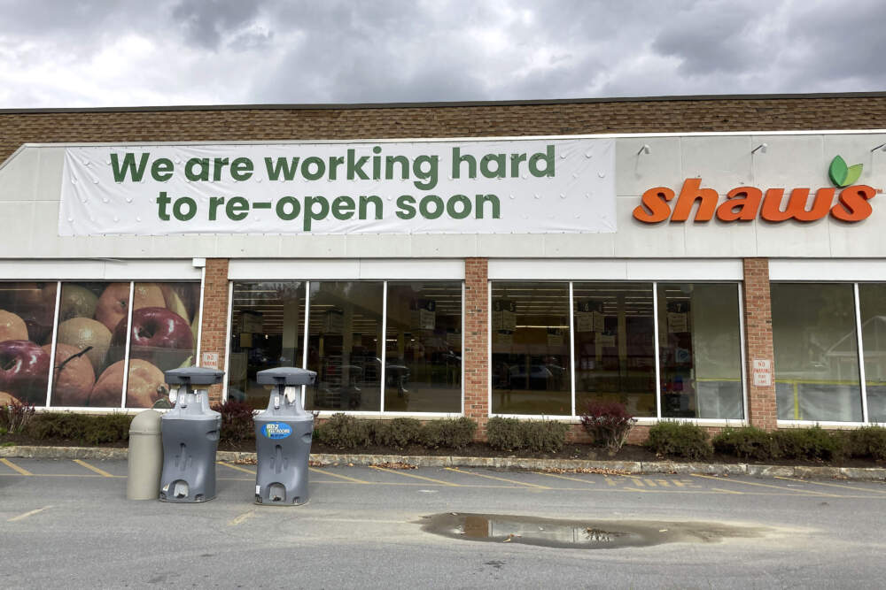 A sign is attached to the exterior of a closed grocery store, Thursday, Oct. 19, 2023, in Ludlow, Vt., three months after severe flooding hit the ski town. (Lisa Rathke/AP)
