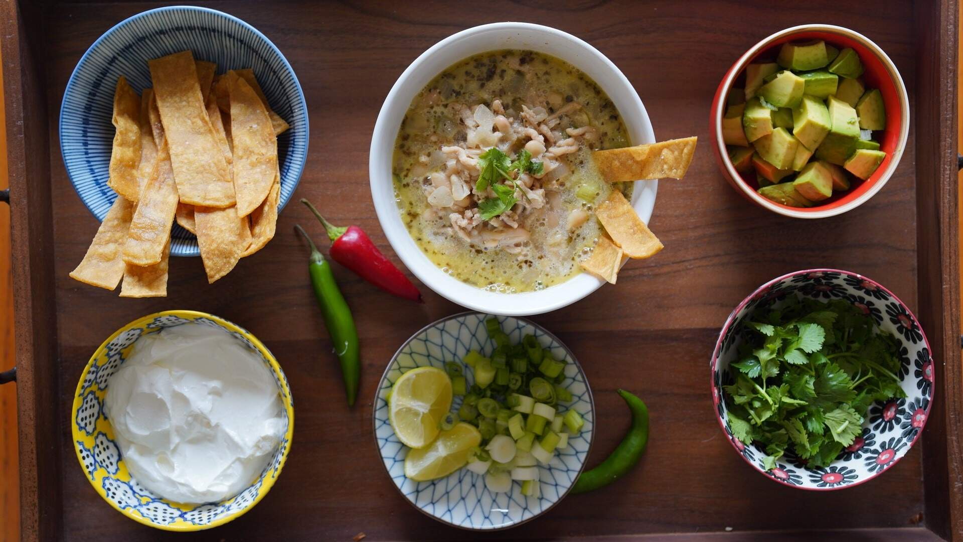 Chicken and white bean chili with tortilla strips plus garnishes. (Kathy Gunst/Here &amp; Now)