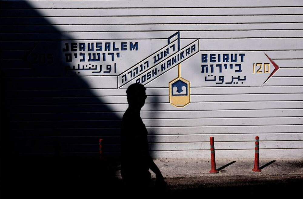 A man walks past a sign with the distance to Jerusalem and Beirut from the Israeli-Lebanon border in Rosh HaNikra in northern Israel on October 12, 2023. (Thomas Coex/AFP via Getty Images)