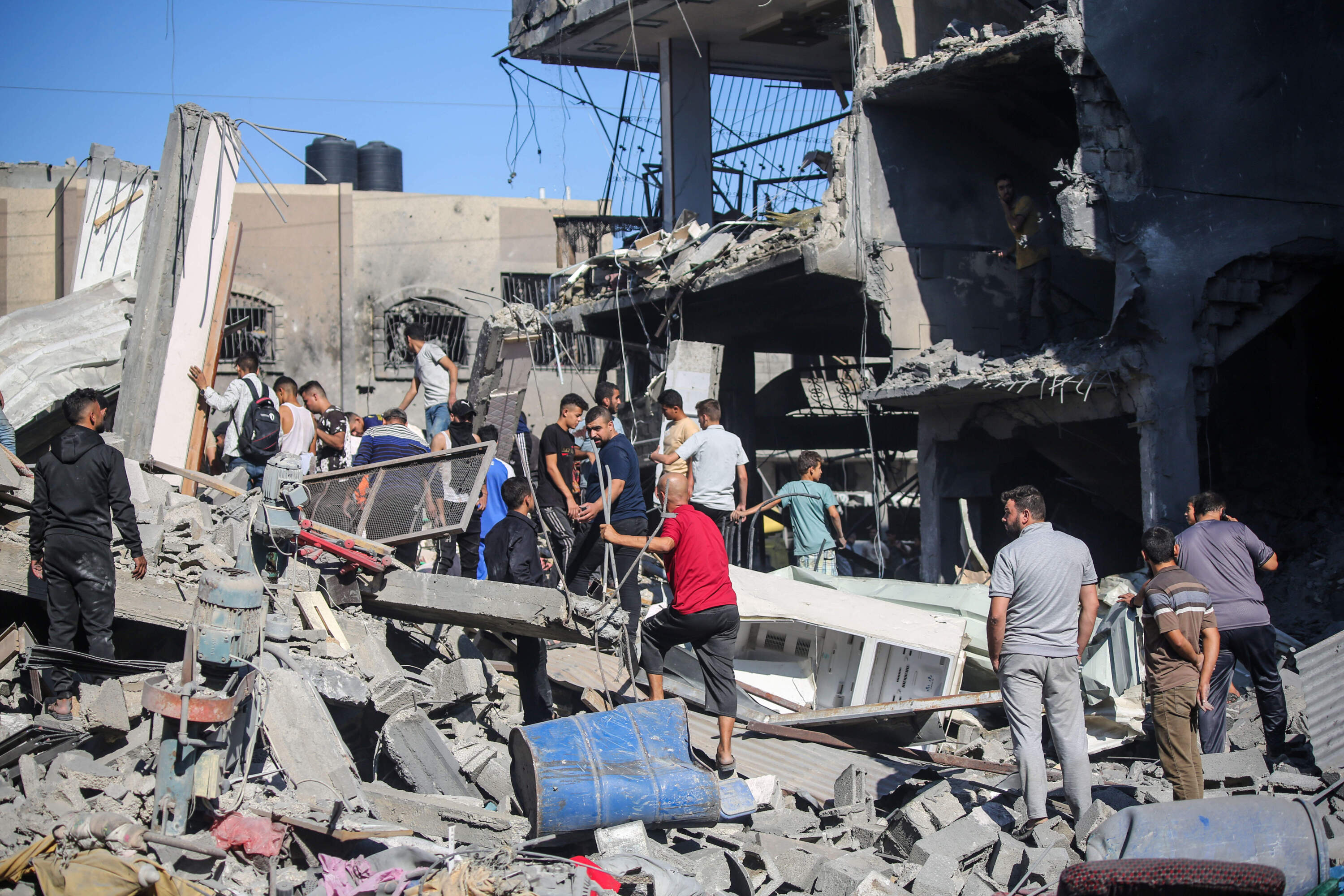 Palestinian emergency services and local citizens search for victims in buildings destroyed during Israeli raids in the southern Gaza Strip on Oct. 17, 2023 in Khan Yunis, Gaza. (Ahmad Hasaballah/Getty Images)