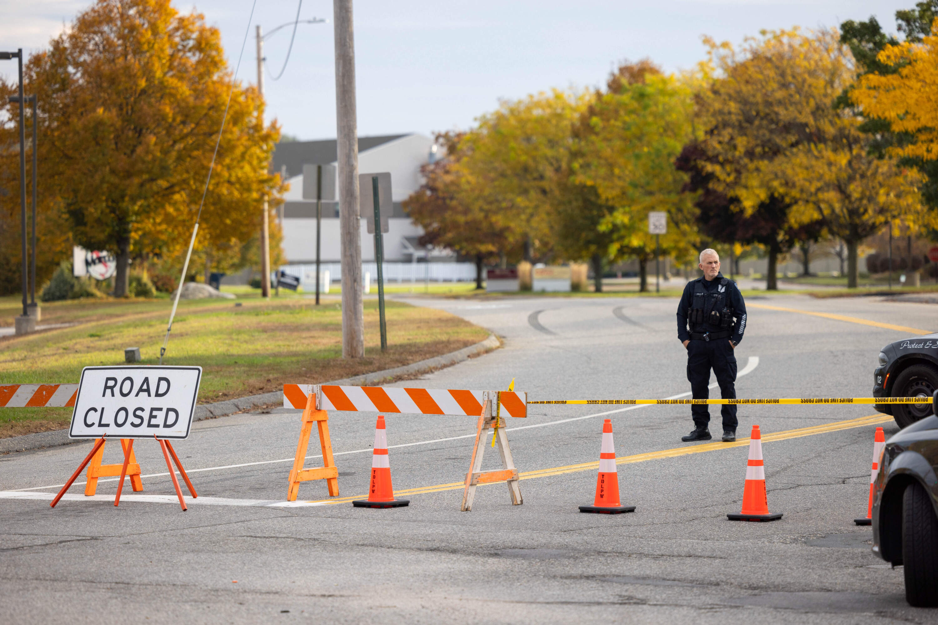 A police officer blocks access to the road to Sparetime Recreation on Oct. 26, 2023 in Lewiston, Maine. (Scott Eisen/Getty Images)