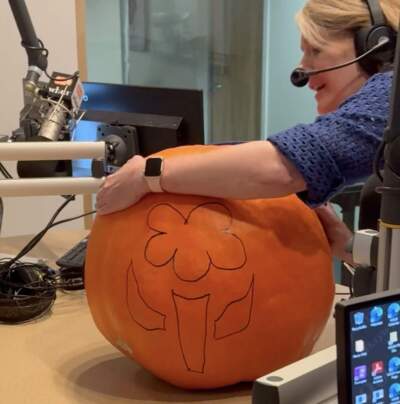 Radio Boston host Tiziana Dearing prepares to carve a pumpkin in the WBUR studios. (Khari Thompson/WBUR)