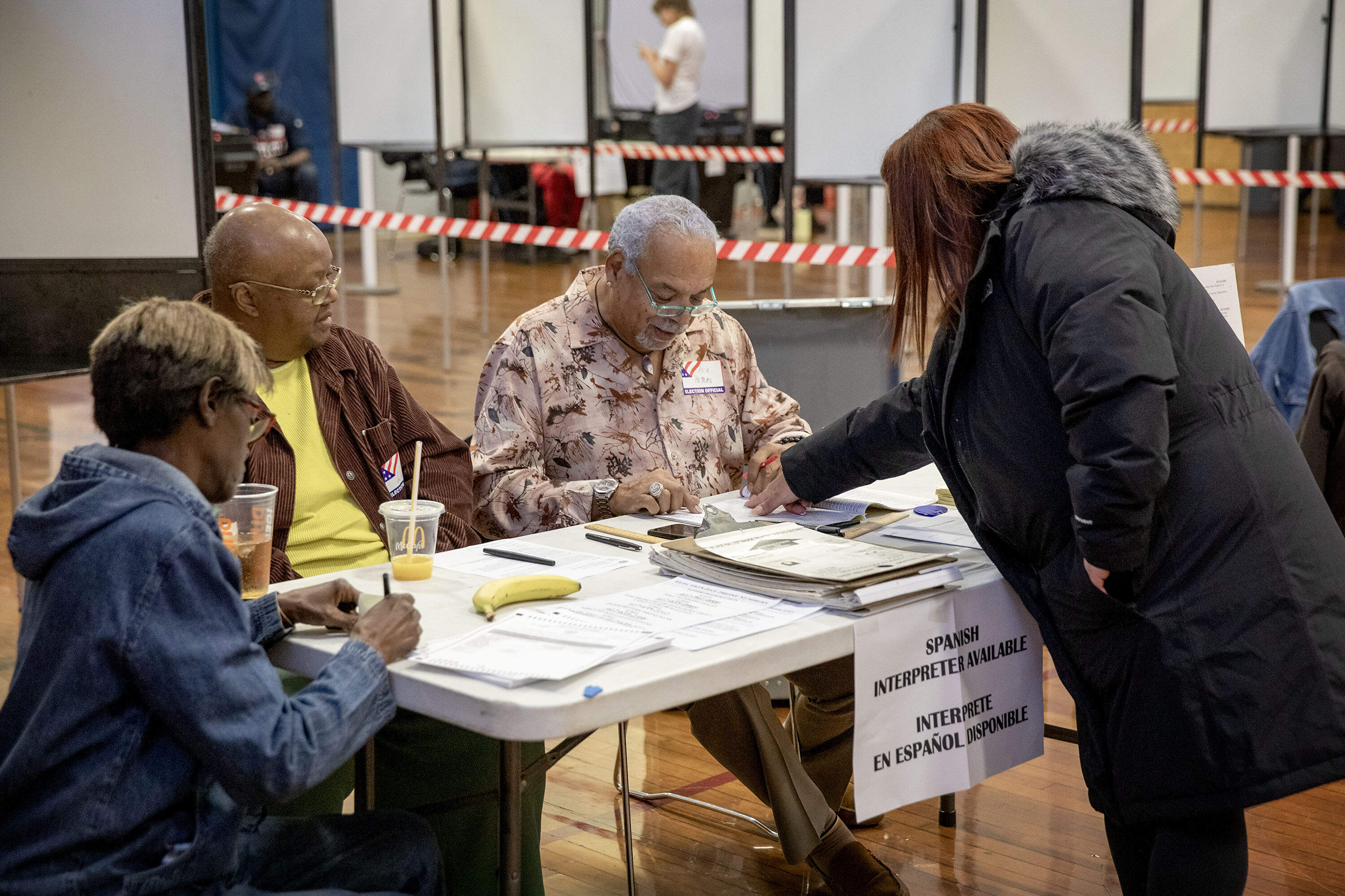 A voter points to her name on the voter list at the Higginson-Lewis School in Roxbury. (Robin Lubbock/WBUR)