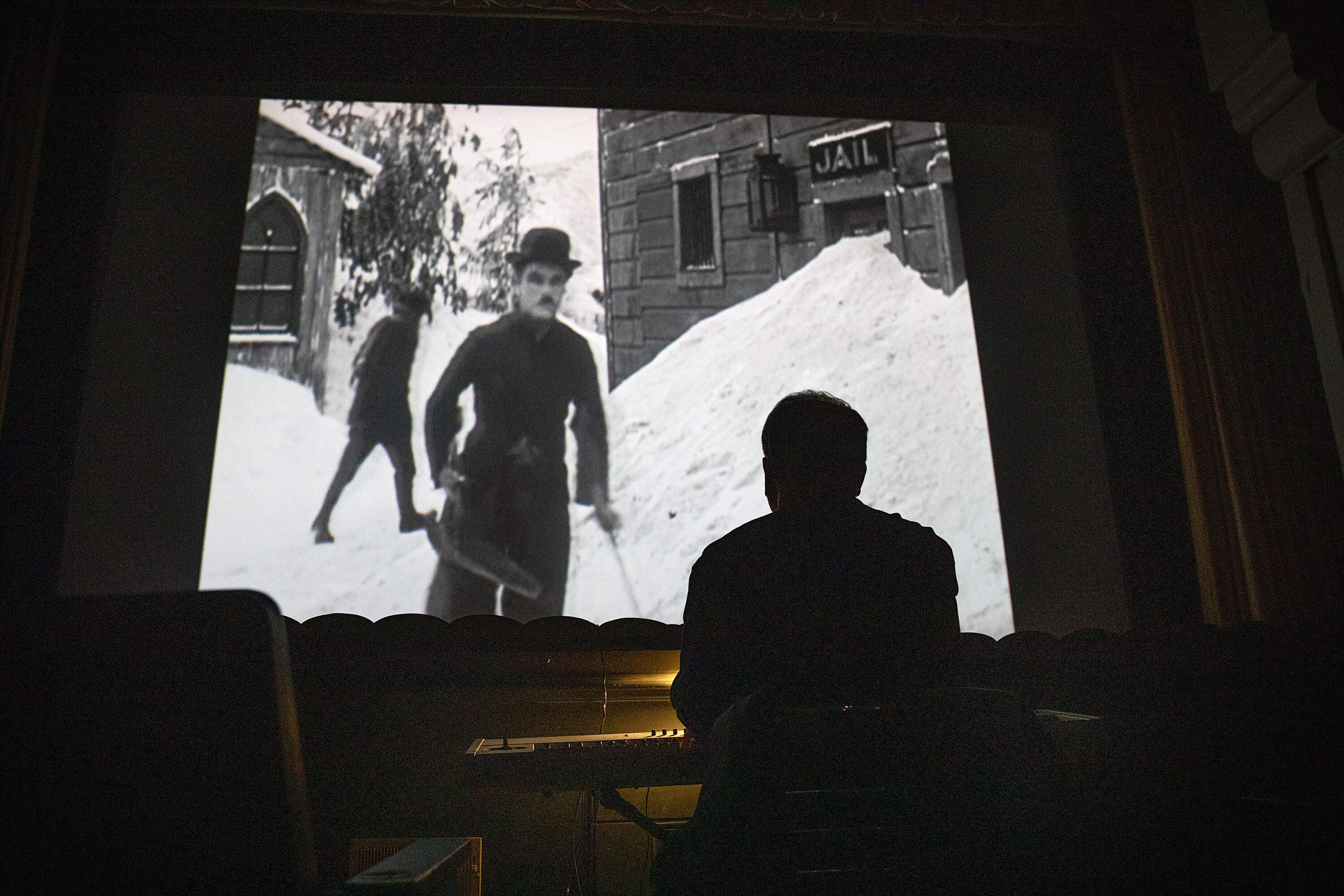 Jeff Rapsis plays music to accompany "The Gold Rush" starring Charlie Chaplin, at the Jane Pickens Theatre in Newport, Rhode Island. (Robin Lubbock/WBUR)