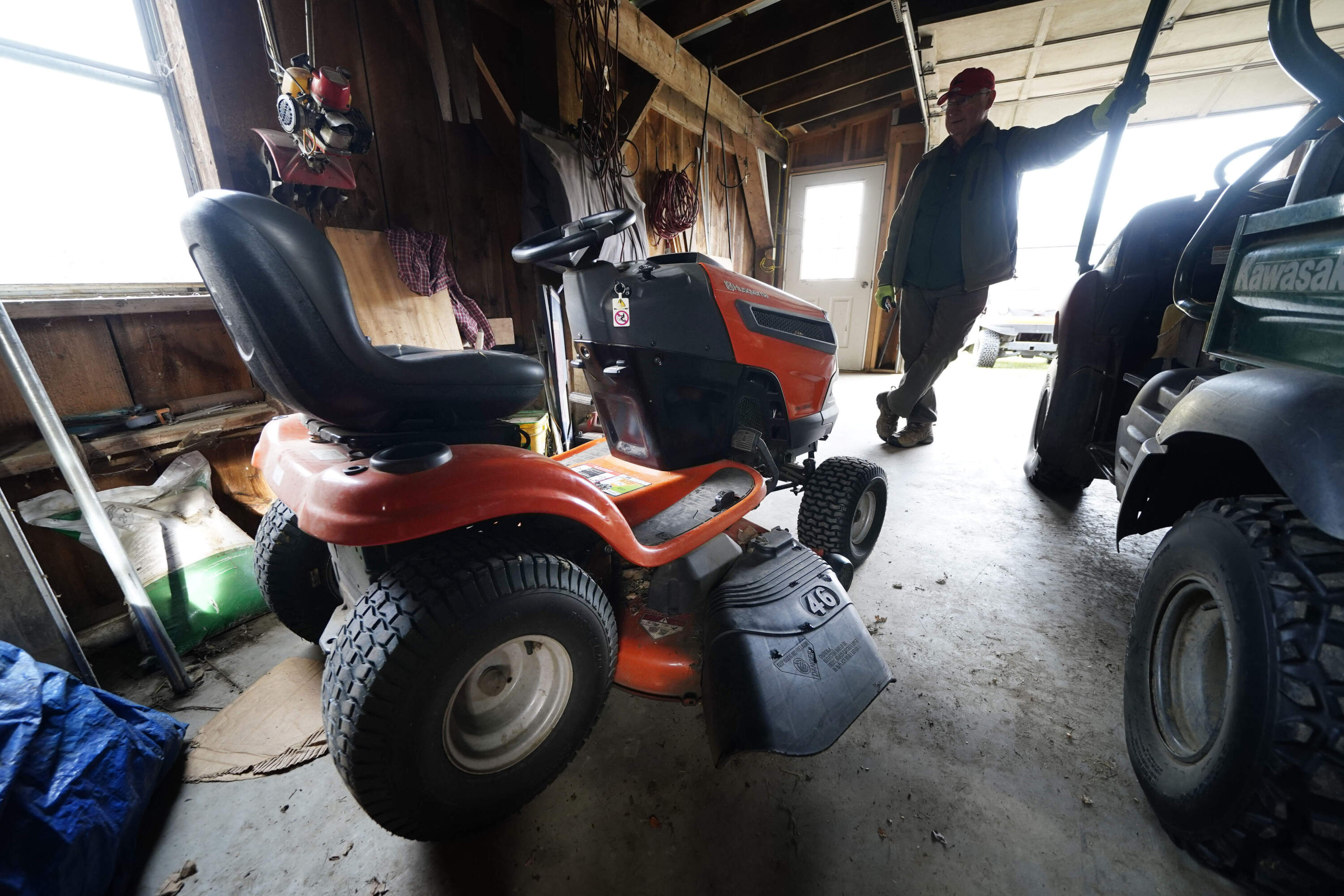 Trailer park owner Ed Smith looks at one of Geoffrey Holt's riding mowers at Stearns Park. (Robert F. Bukaty/AP)