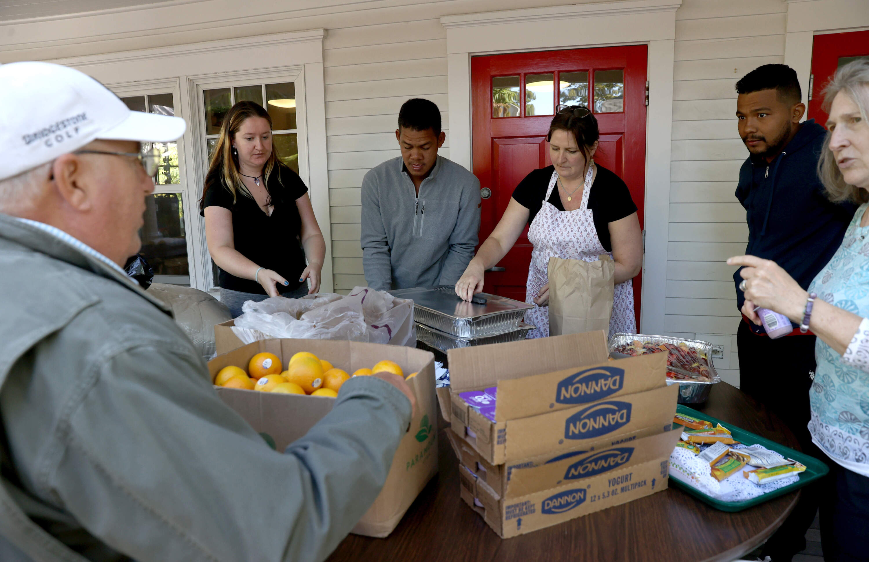 Volunteers helped serve food to the Venezuelans when they arrived on Martha's Vineyard. (Jonathan Wiggs/The Boston Globe via Getty Images)