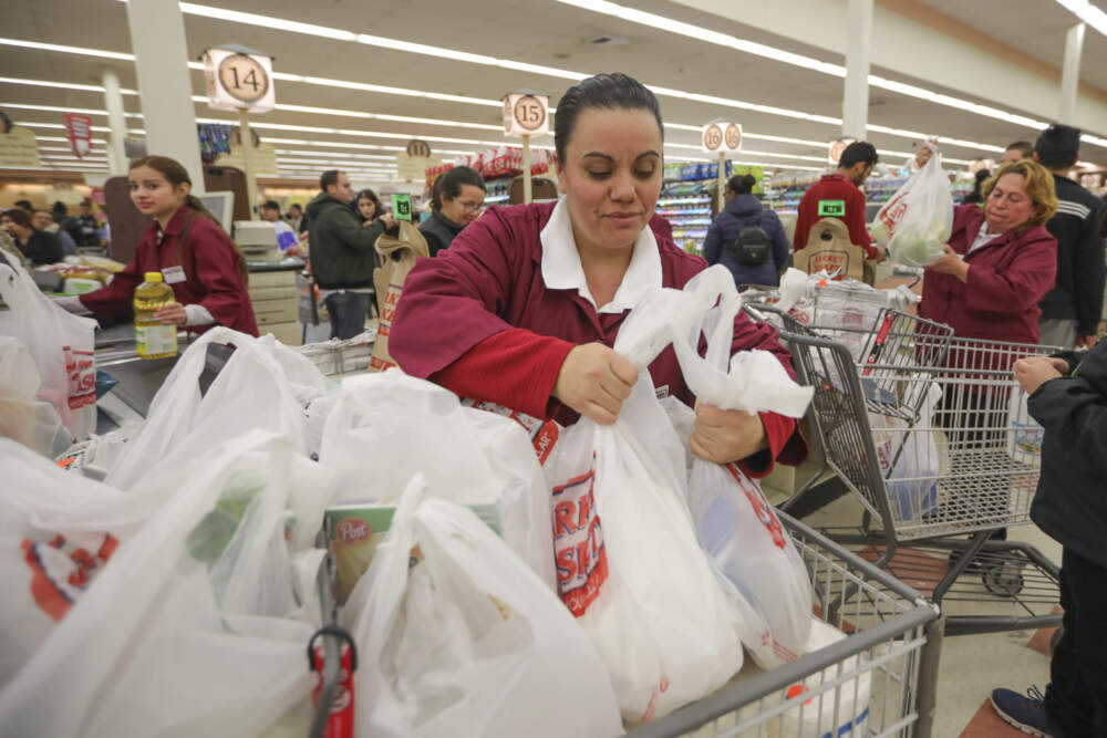 Sales associate Aracely help a shopper load up as shoppers stock up at the Chelsea Market Basket before a winter storm in 2019. (Nicolaus Czarnecki/MediaNews Group/Boston Herald via Getty Images)