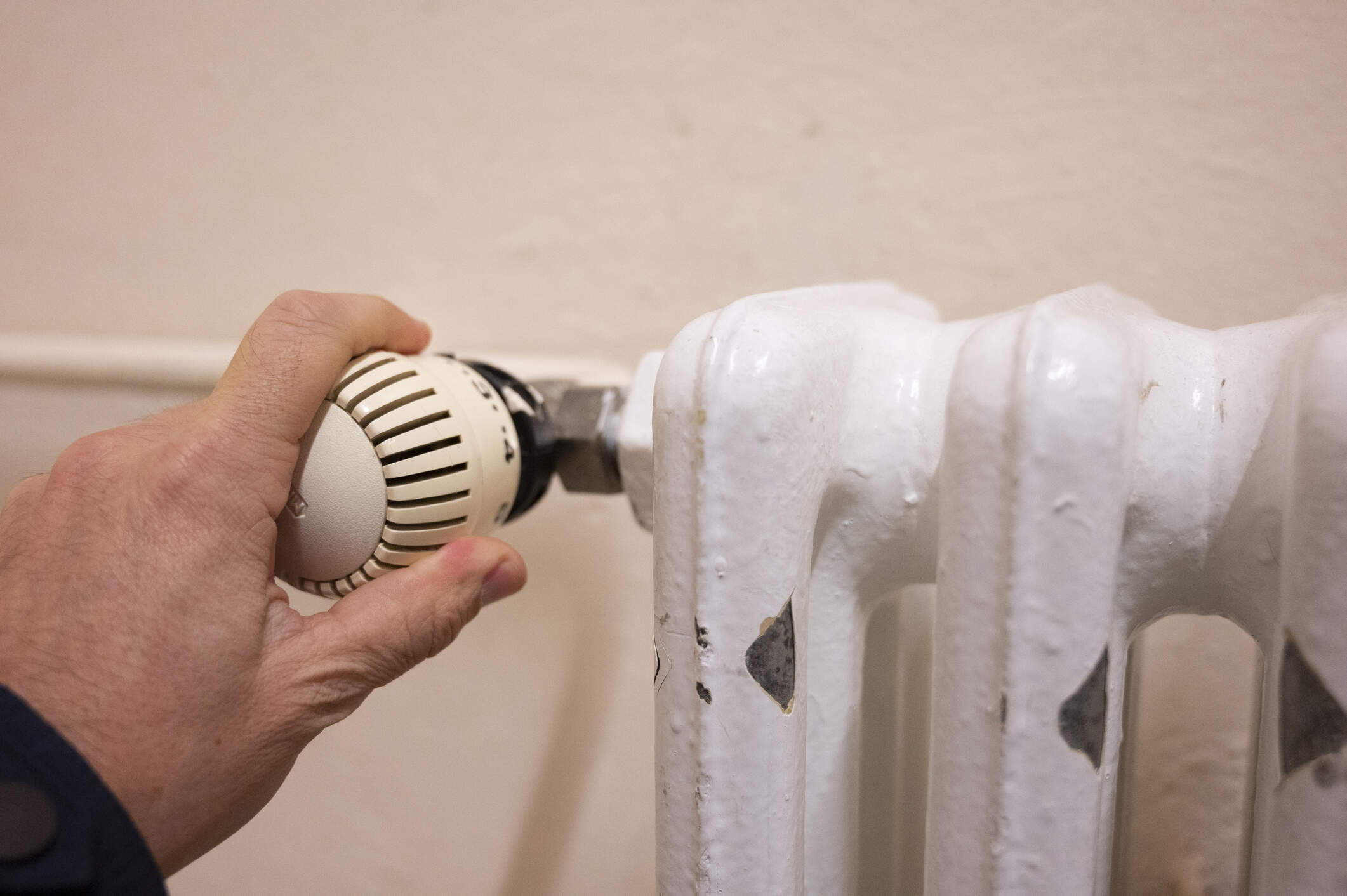 Person adjusting the temperature of a radiator. (Getty Images)