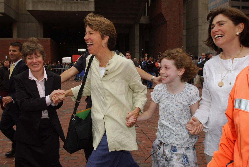 Hillary Goodridge, Julie Goodridge, their daughter Annie and lawyer Mary Bonauto celebrate as they leave City Hall in Boston, Massachusetts, May 17, 2004, after the Goodridges became the first same-sex couple in the city of Boston to be allowed to apply for a marriage license. (STAN HONDA/AFP via Getty Images)