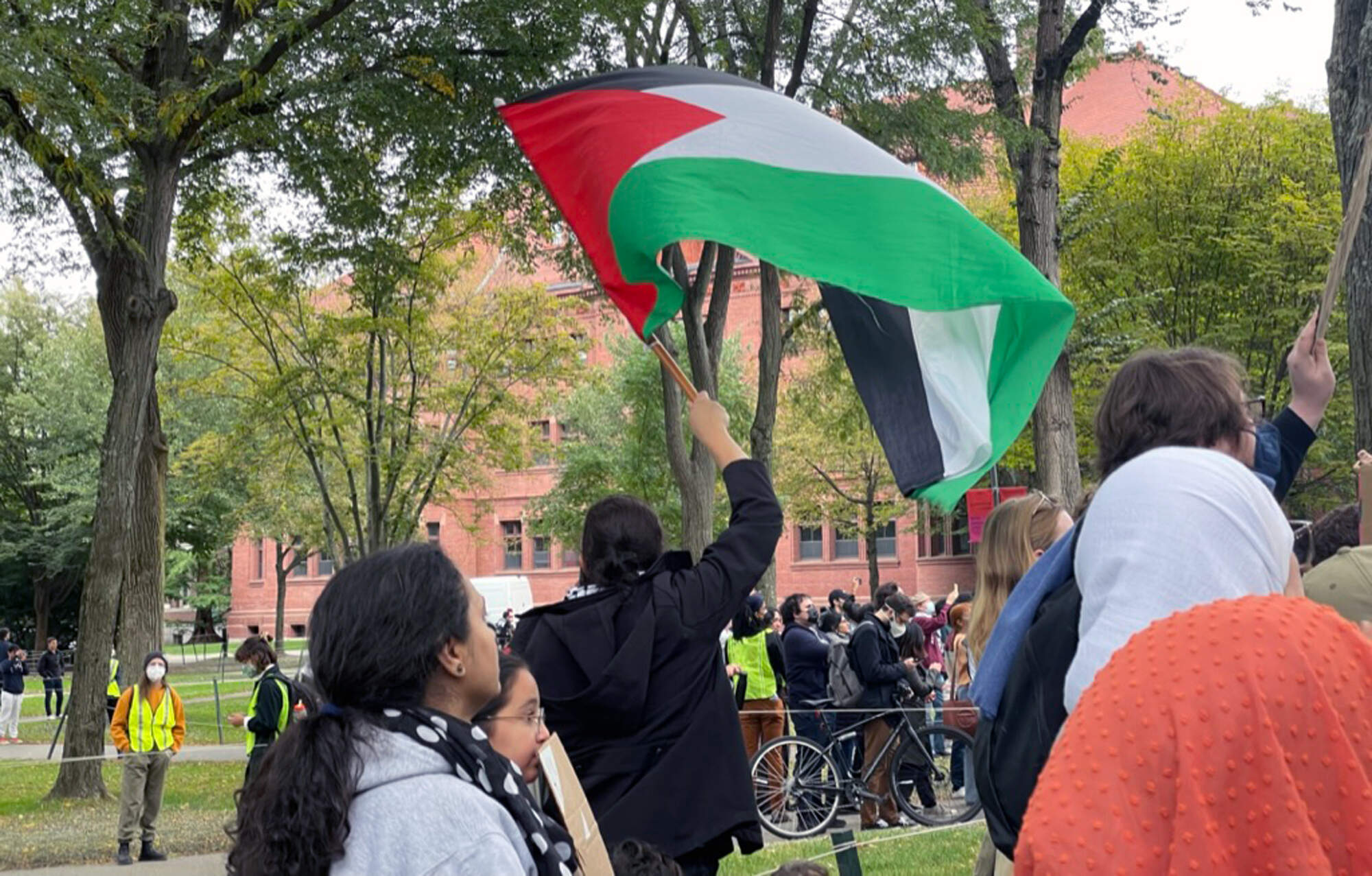 A Palestinian flag waves at an Oct. 14 rally in Harvard Yard. (Max Larkin/WBUR)