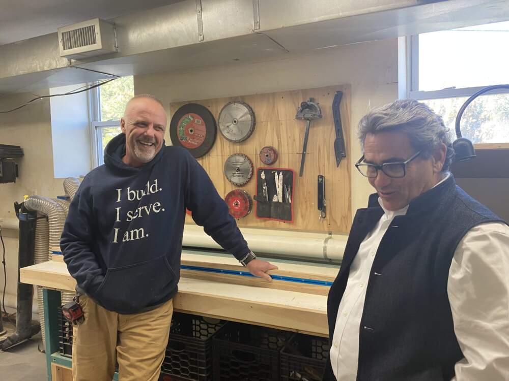 Duncan Coakley, left, of the nonprofit YouthBuild, talks shop with District 3 Councilor Frank Baker. (Simón Rios/WBUR)