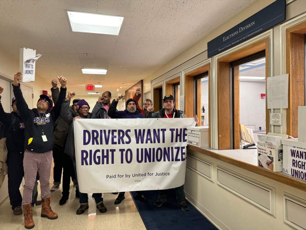 Rideshare drivers and union organizers deliver the final boxes of certified signatures to the Secretary of State's office. (Walter Wuthmann/WBUR)
