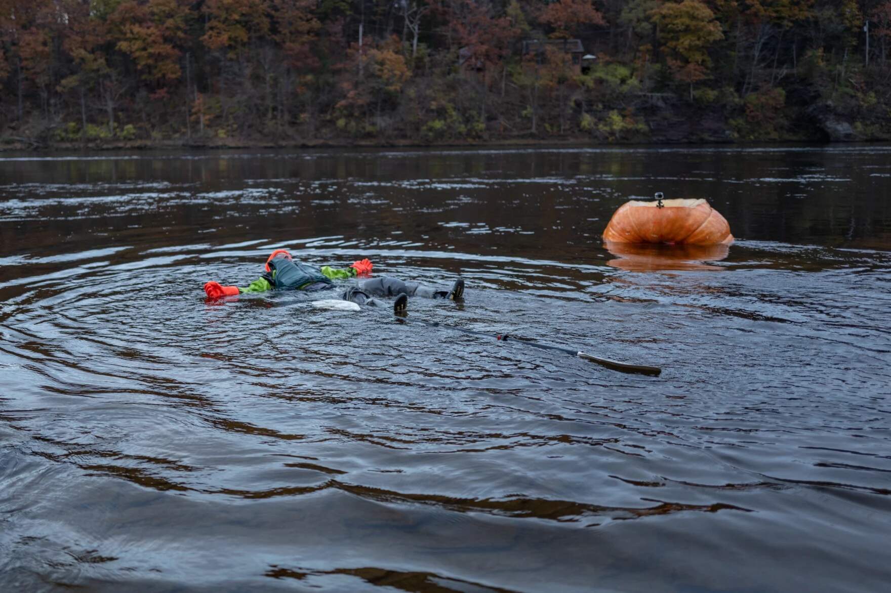 After traveling 40 miles over three days, David Rothstein takes an accidental dunk in the Connecticut River while disembarking in Holyoke, Massachusetts. (Ben James/NEPM)