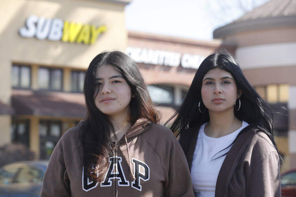 San Antonio High School students Lorenza Tapia, 16, left, and Alessandra Chavez, 16, stand outside the Subway sandwich shop at the intersection of Lakeville Street and Caufield Lane in Petaluma, Wednesday, March 15, 2023. (Beth Schlanker/The Press Democrat)