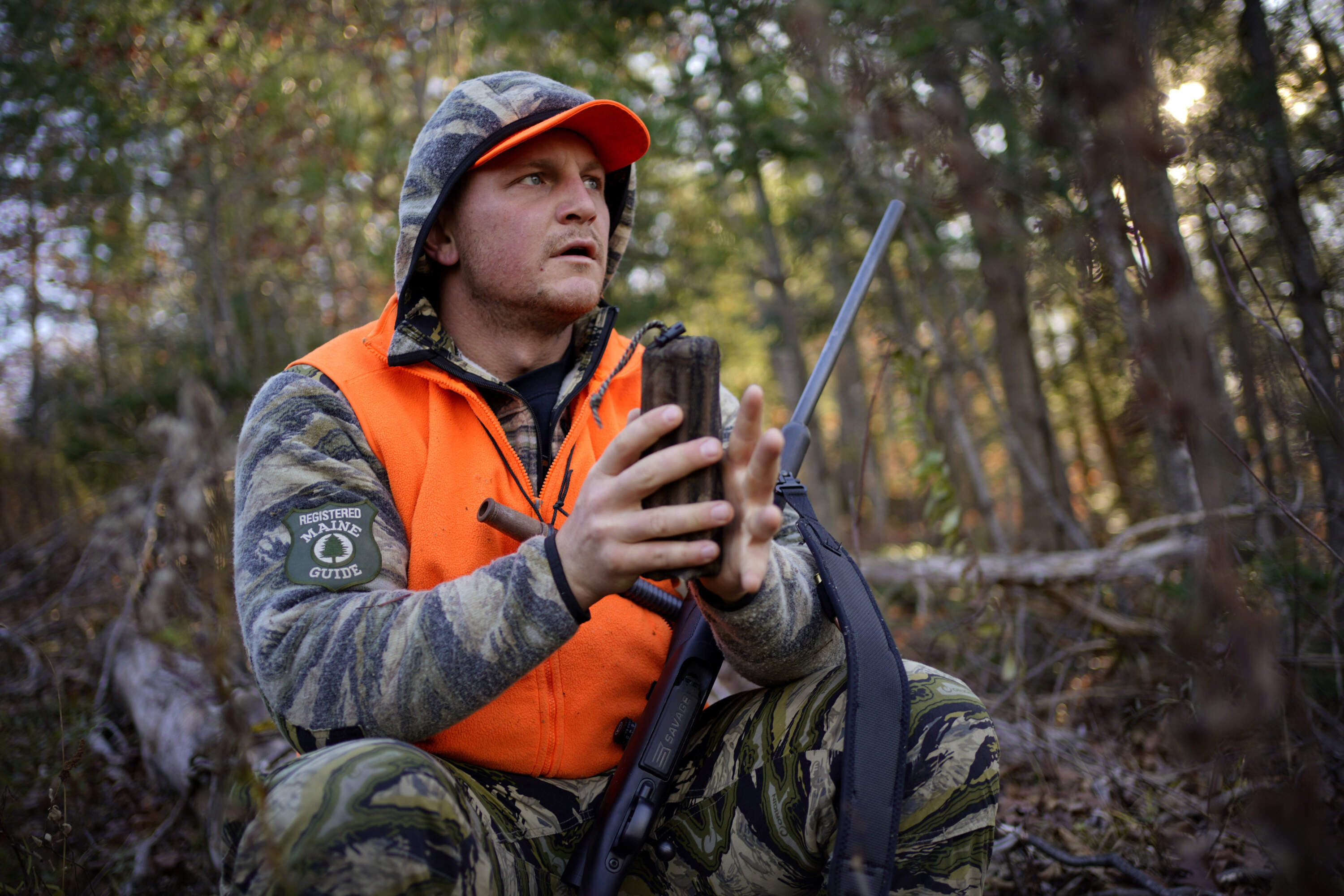 Jared Bornstein uses a rattle bag to mimic the sound of clashing antlers while attempting attract a buck while deer hunting Saturday, Nov. 11, 2023, in Turner, Maine. (Robert F. Bukaty/AP)