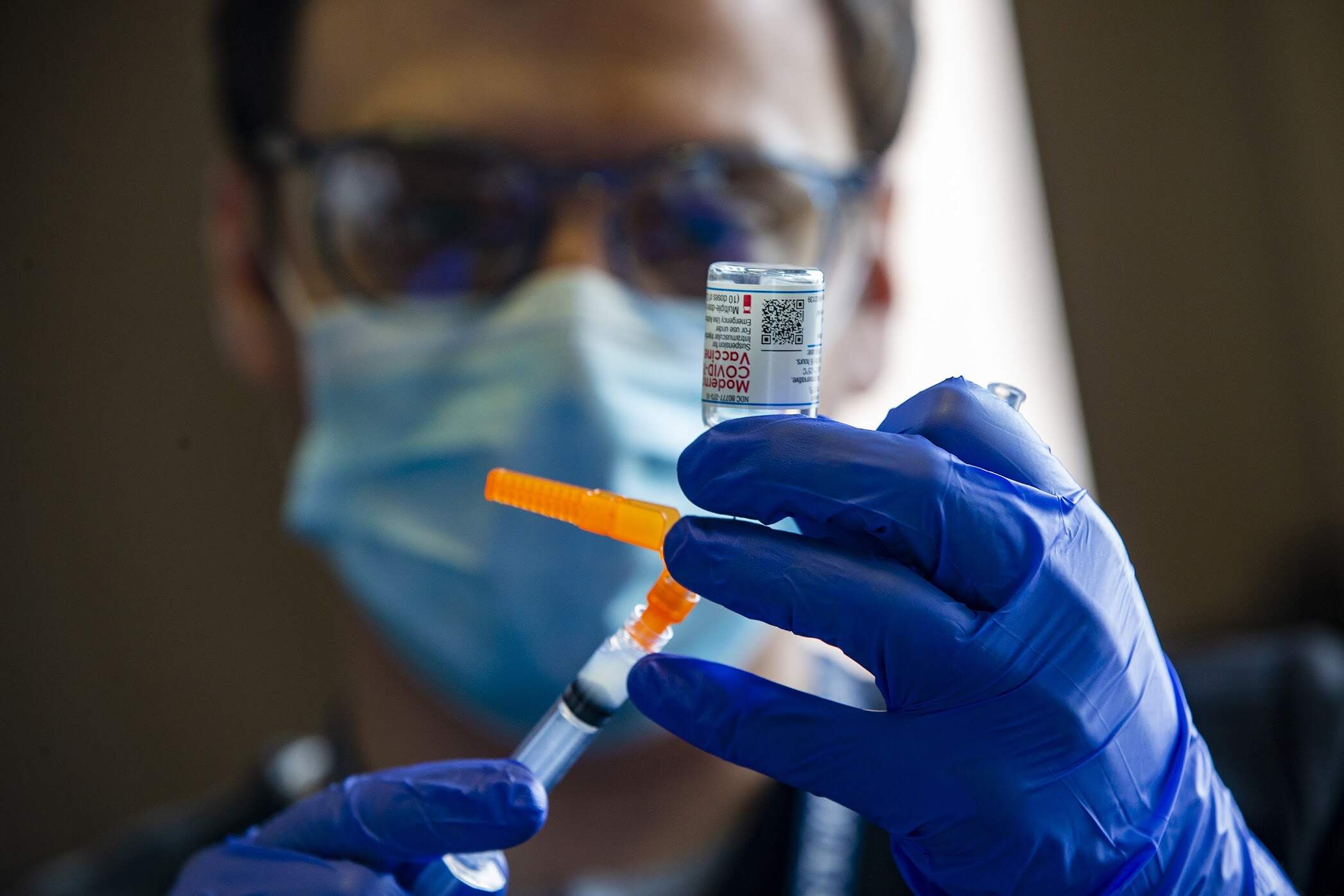 A UMass surgical medical student prepares doses of the Moderna COVID-19 vaccine in 2021. (Jesse Costa/WBUR)