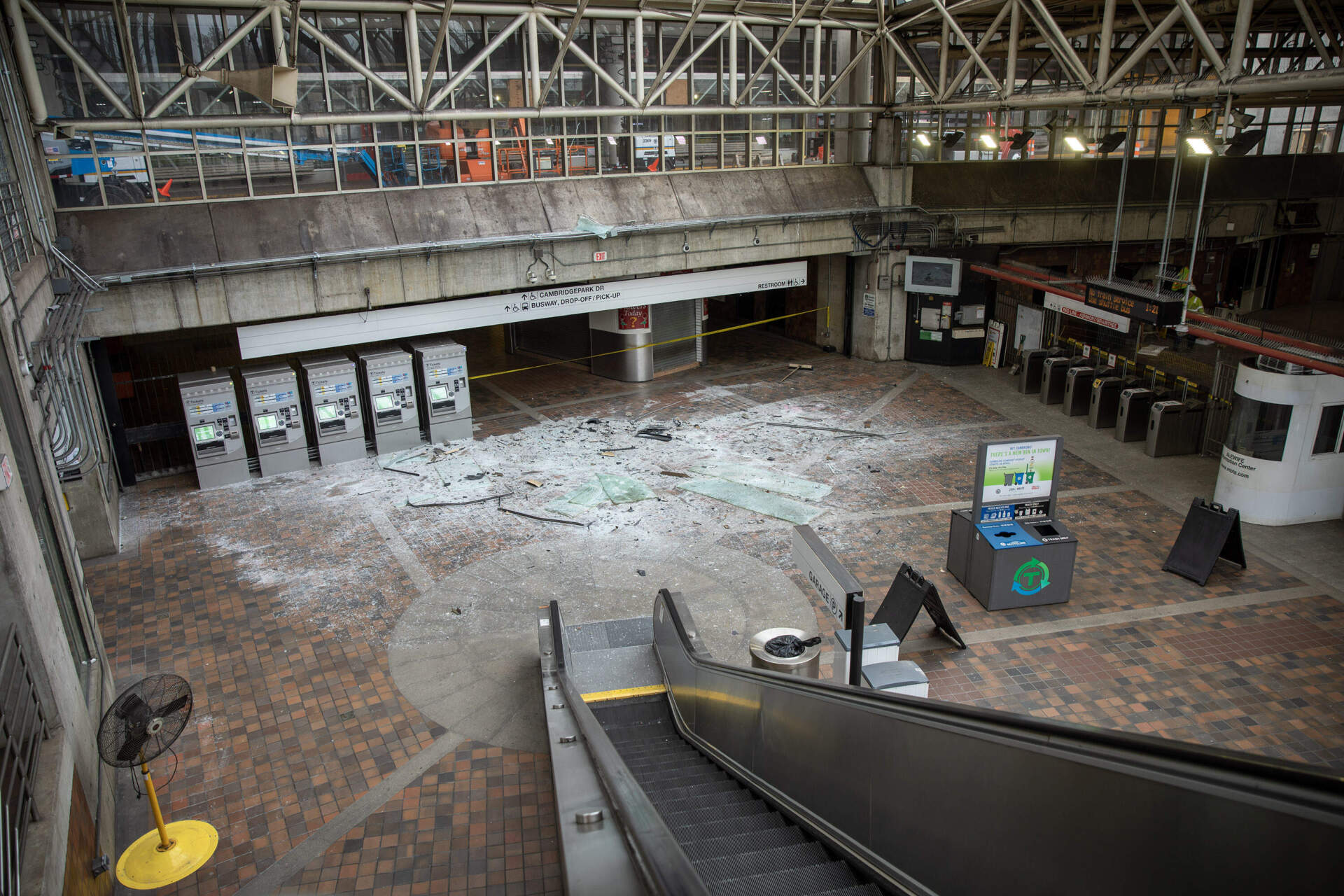 The concourse at Alewife MBTA station, with the floor covered in broken glass, after a driver crashed into a car park wall causing it to fall onto the station atrium. (Robin Lubbock/WBUR)
