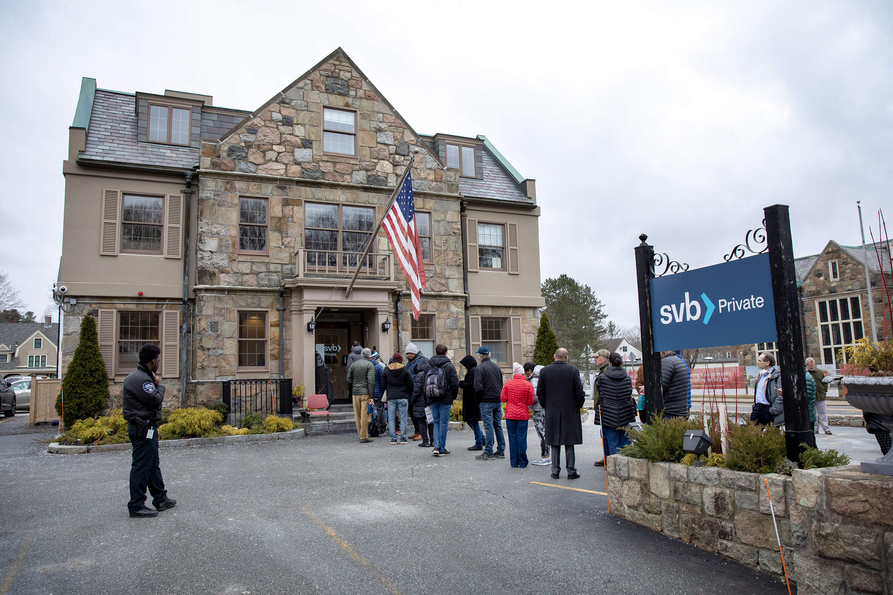 People wait in line outside the Silicon Valley Bank in Wellesley. (Robin Lubbock/WBUR)