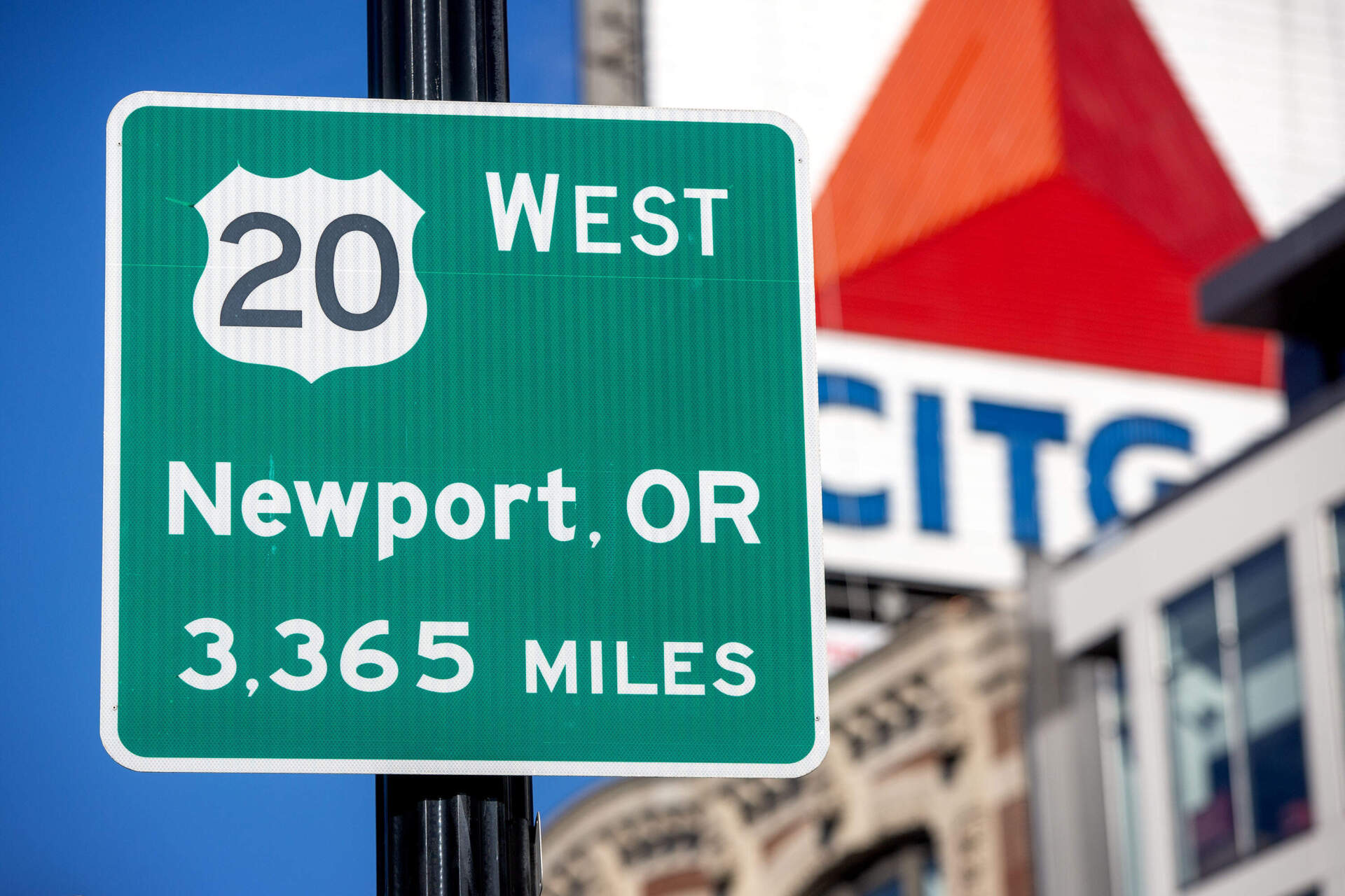 A sign in Boston's Kenmore Square reminds visitors that they can follow Route 20 west for 3,365 miles, all the way to Newport, Oregon. (Robin Lubbock/WBUR)